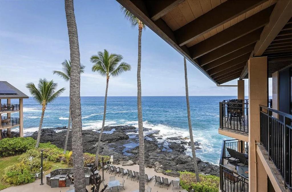 a view of the ocean from a hotel balcony at Oceanfront Penthouse with Loft in Kailua-Kona