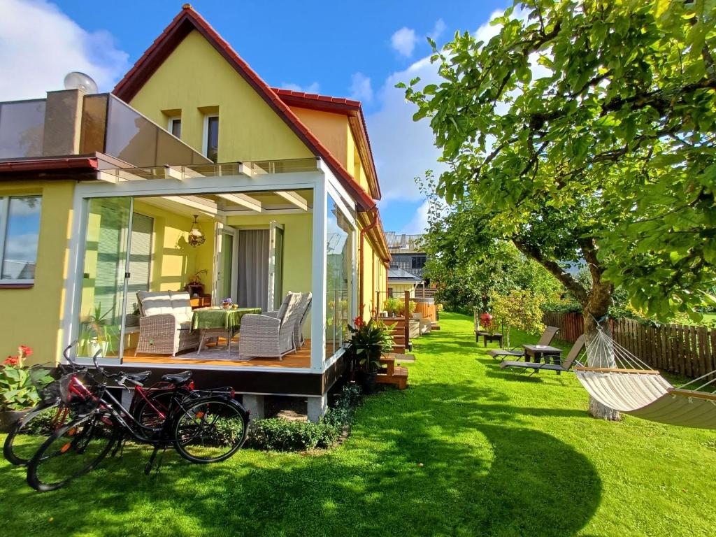 a house with a bike parked in the yard at Pärnu Posti Apartment in Pärnu