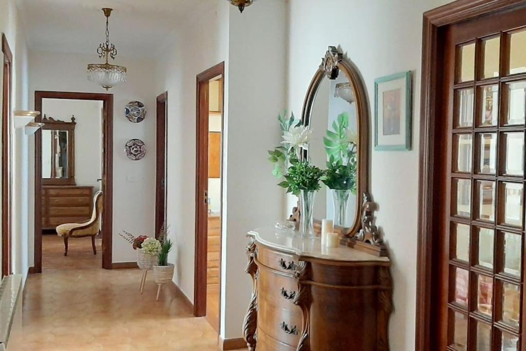 a bathroom with a mirror and a wooden sink at Arrochela apartamento in Ribeira