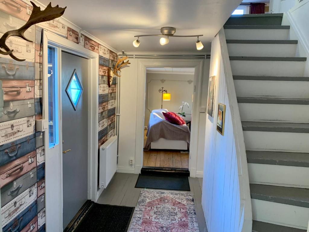 a hallway with stairs leading to a bedroom at Flemma Gård Wing residence with lake view in Vreta Kloster