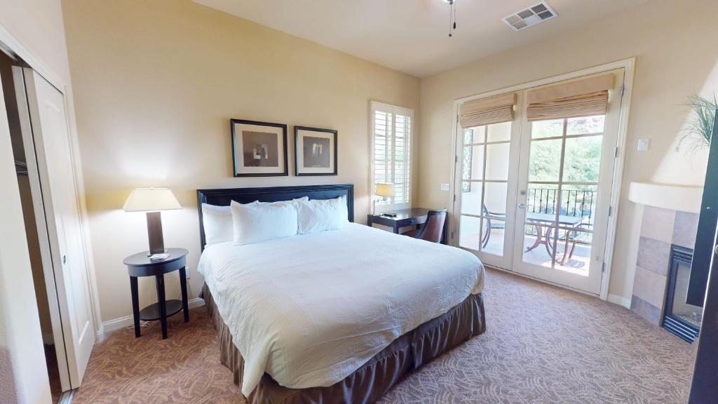 a bedroom with a large bed and a large window at LV030 Private Upstairs Studio w Mountain Views in La Quinta