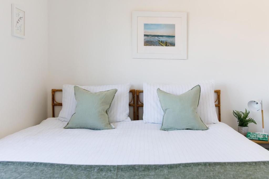 a white bed with white sheets and pillows at Sanderling House, walk to beach in Earnley
