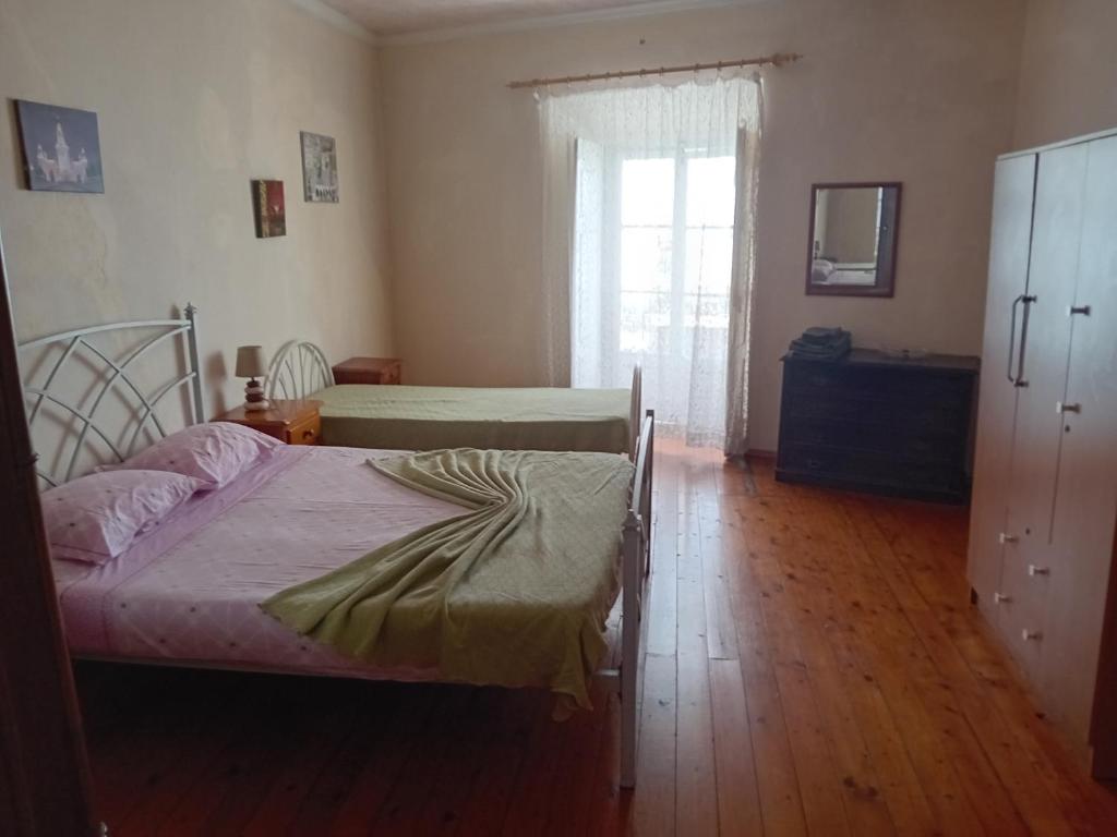 a bedroom with two beds and a window at T2 N16 Ref 006 in Tavira