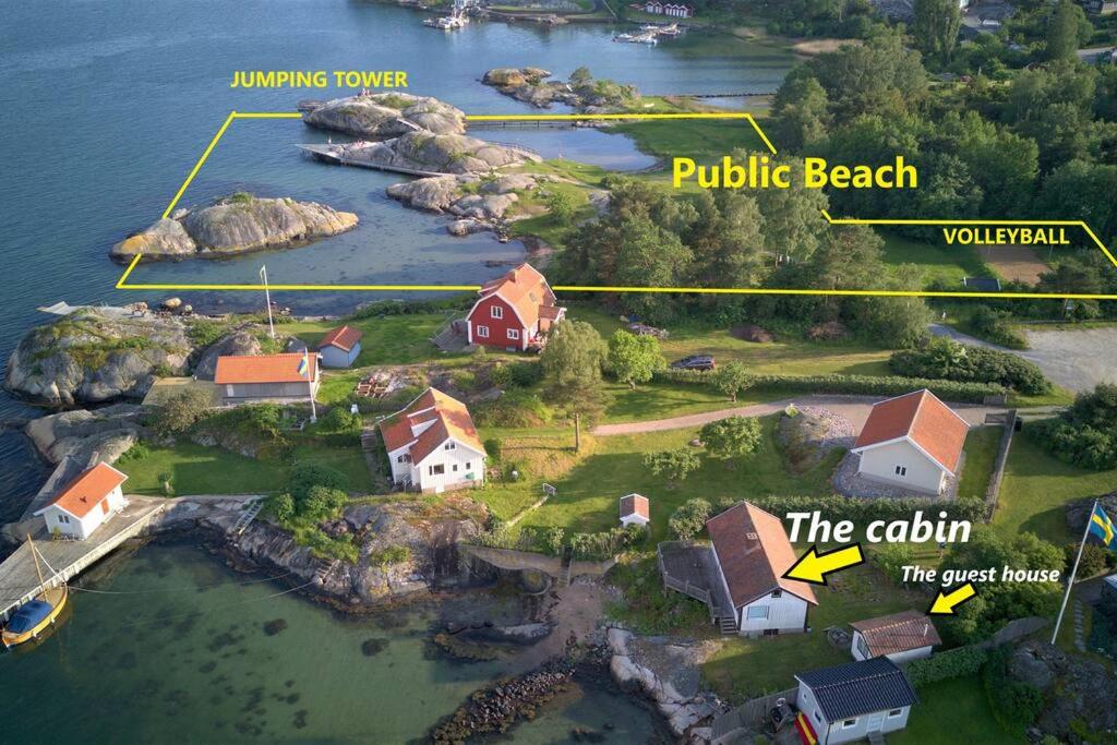 an aerial view of a house on an island in the water at Cabin at the sea. public beach close with jumpingtower. in Höviksnäs