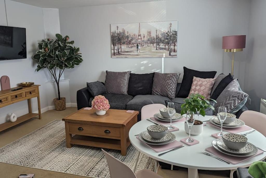 a living room with a table and a couch at Turtle Dove Apartment in Oxford