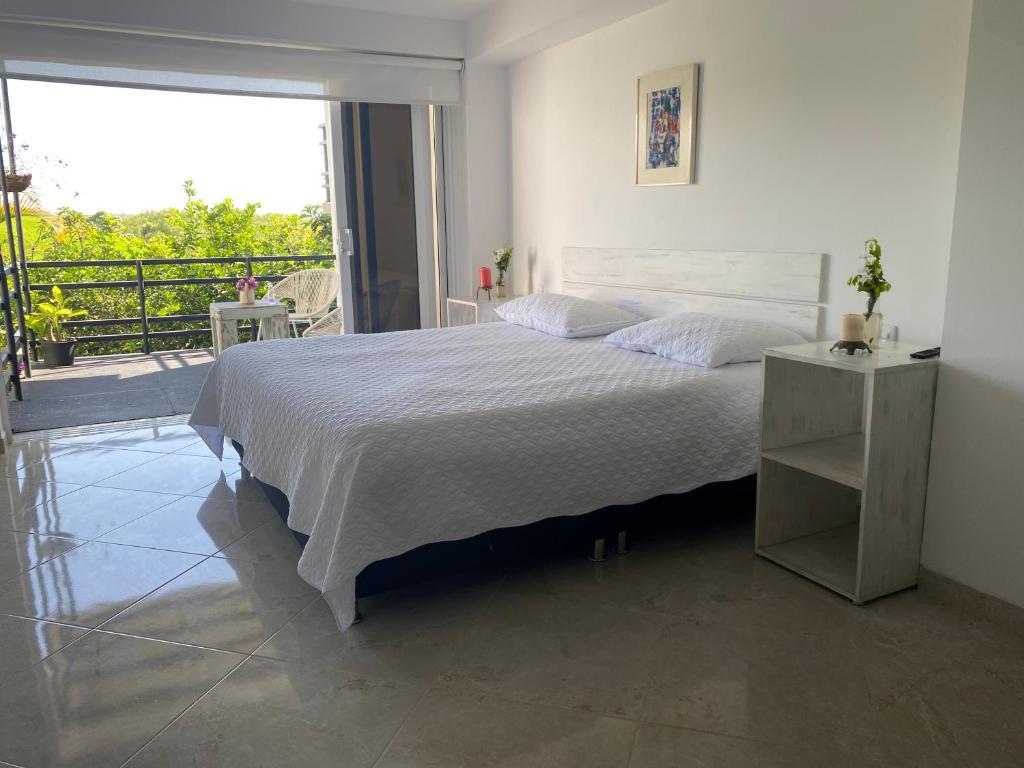 Postel nebo postele na pokoji v ubytování Hotel Casa Natura