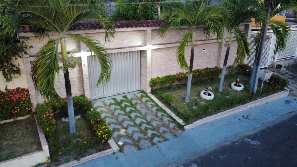 - une vue aérienne sur une maison avec des palmiers dans l'établissement Excelente Casa no Bairro Mundo Novo com piscina, à Manaus