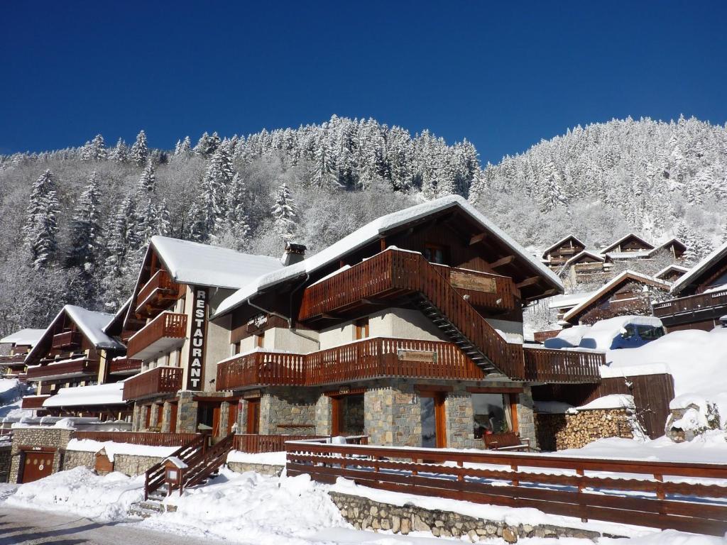 a ski lodge in the snow with snow covered trees at Les Glières - Champagny-en-Vanoise in Champagny-en-Vanoise