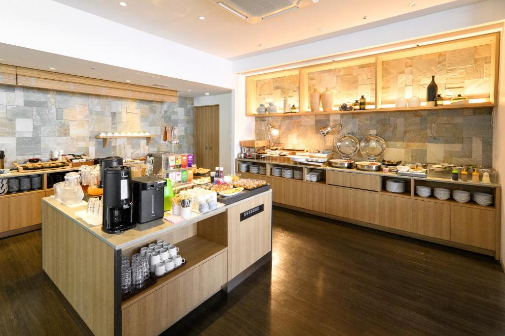 a large kitchen with many counters in a restaurant at Hotel Forza Oita in Oita
