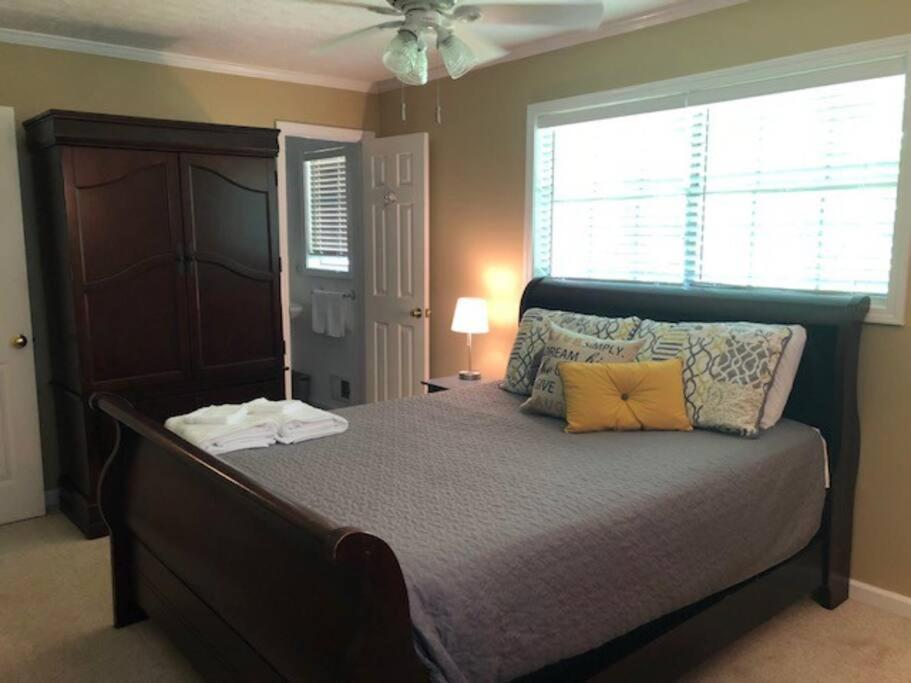 a bedroom with a bed with two pillows on it at Quiet Kennesaw 3BR home - close to KSU, Lakepoint in Kennesaw