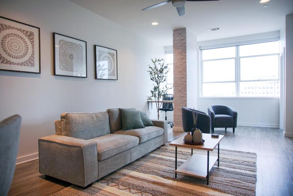 a living room with a couch and a table at Stylish Downtown High-Rise - 2BD in Baton Rouge