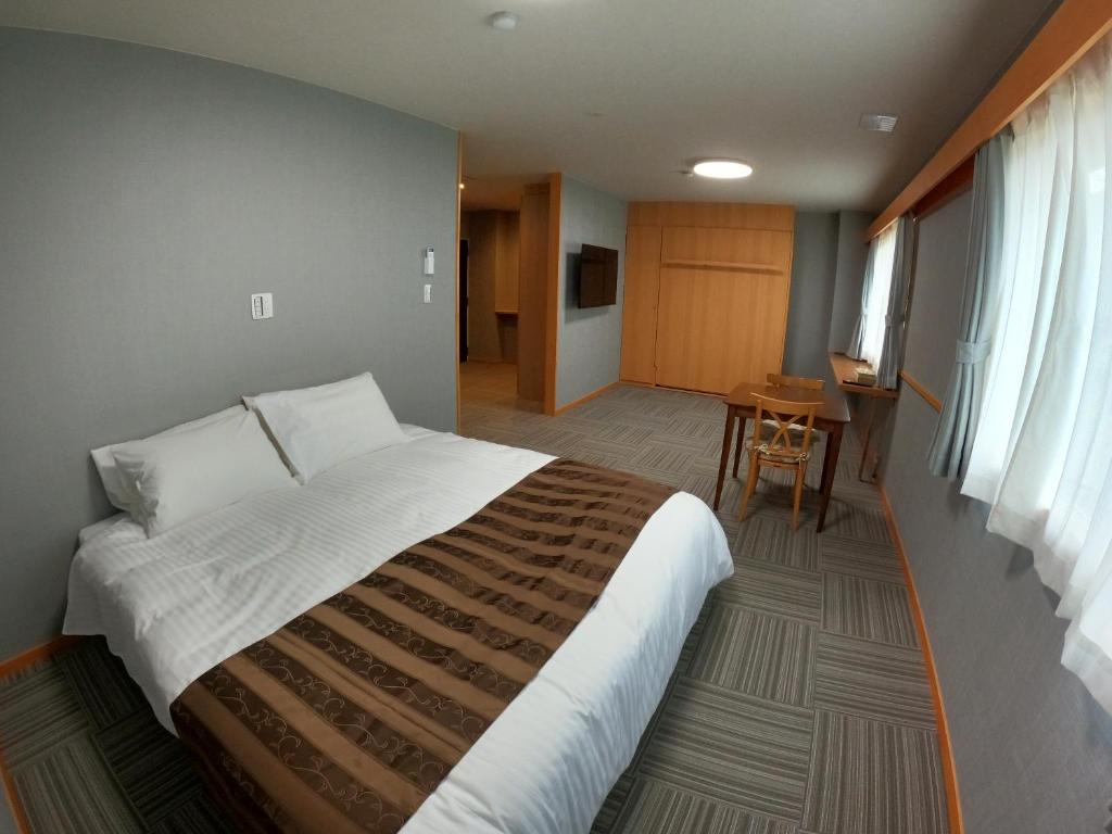 Postel nebo postele na pokoji v ubytování Hotel Takimoto