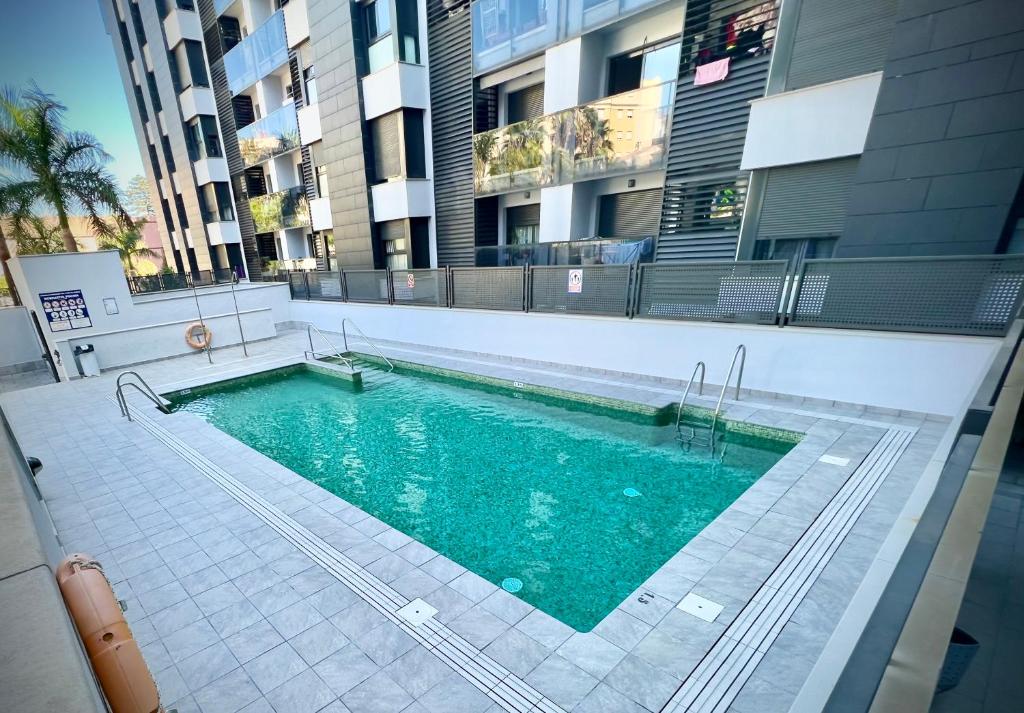 - une piscine sur le côté d'un bâtiment dans l'établissement Apartamento El Estrecho, à Algésiras