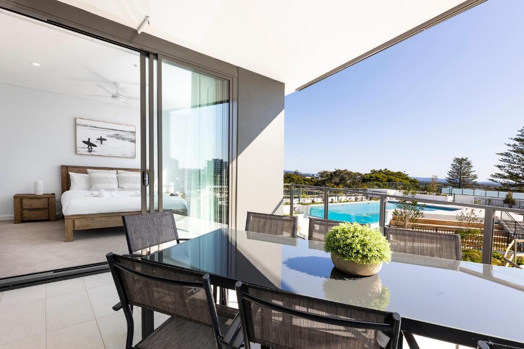 a living room with a table and chairs and a bedroom at Solaris 410 in Forster