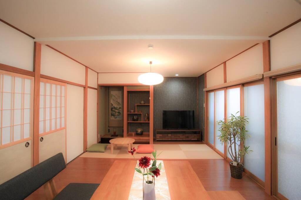 a living room with a couch and a television at 飛騨高山　一の心 in Takayama