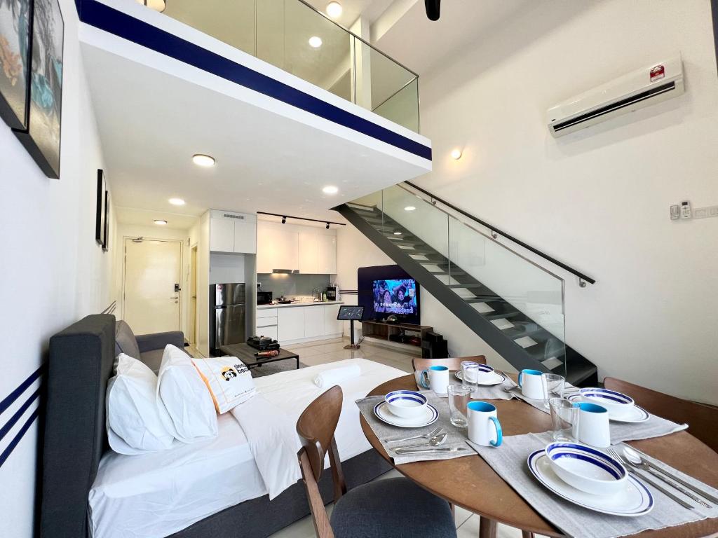 a living room with a bed and a table with chairs at Eko Cheras By Sleepy Bear in Kuala Lumpur