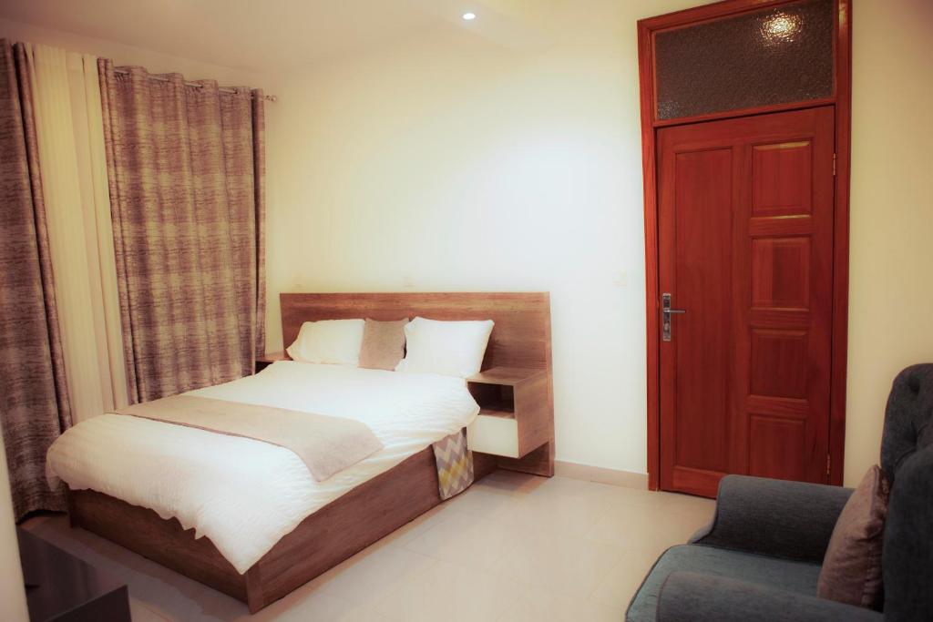 Łóżko lub łóżka w pokoju w obiekcie Kigali Homes & Villas