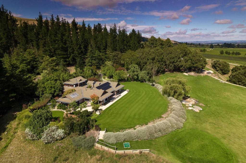 an aerial view of a house on a green field at Kumiko's Guest House in Omihi