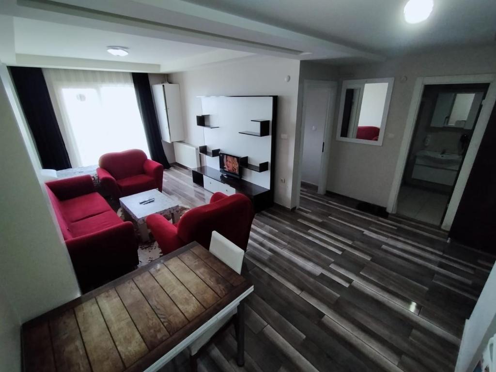 a living room with two red chairs and a couch at Home in love in Esenyurt