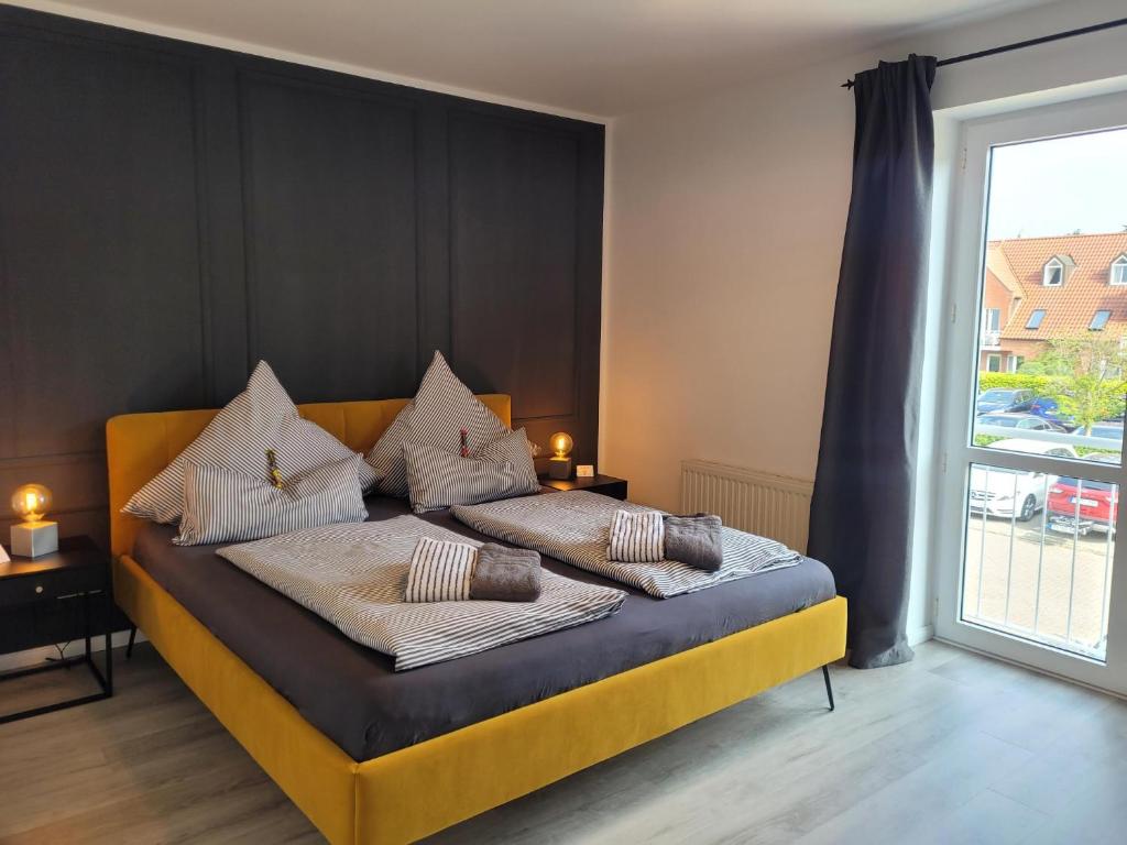 a bedroom with a bed with pillows on it at Heimathafen Hohwacht in Hohwacht