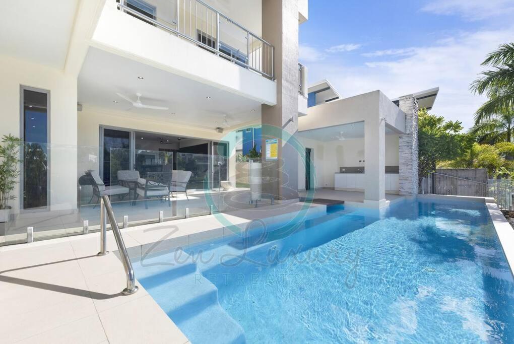 a villa with a swimming pool and a house at Zen Bayview Bliss: Luxury Marina Mansion in Stuart Park