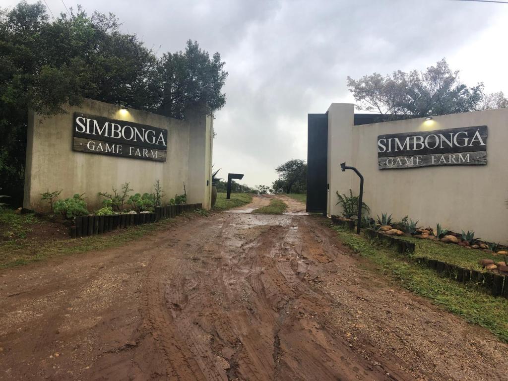 a dirt road with the entrance to a game barn at Simbonga Game Reserve & Sanctuary in Thornhill