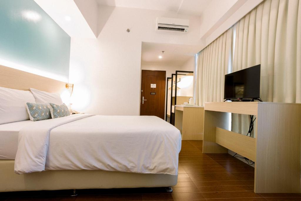 TV a/nebo společenská místnost v ubytování Allure Hotel & Suites
