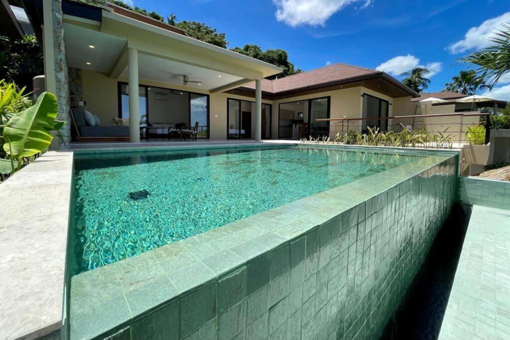 a swimming pool in front of a house at Villa Marie, 2 Bedrooms, Lamai Koh Samui in Koh Samui 