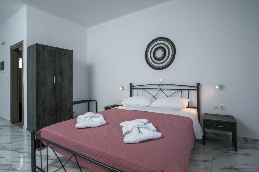 a bedroom with two towels on a bed at Dorian's Domain Faliraki in Faliraki
