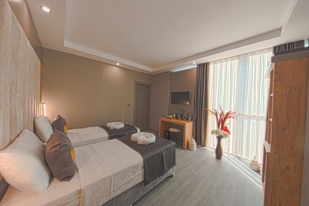 Postel nebo postele na pokoji v ubytování İstanbul City Airport Hotel