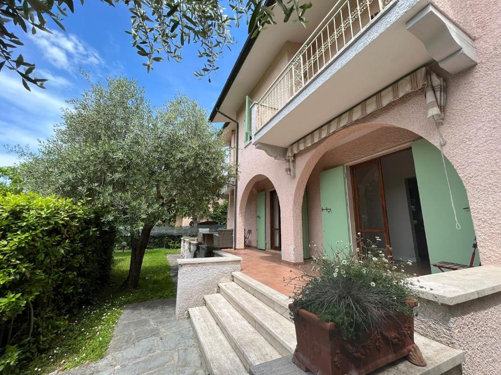 a house with a porch and stairs in front of it at GREAT PRIVATE VILLA for family beach holidays and cultural outings near Forte dei Marmi RECOMMENDED in Marina di Pietrasanta