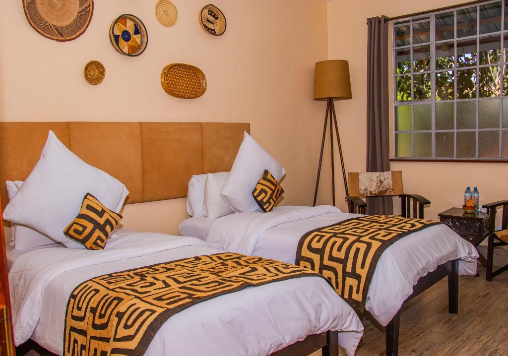 Postel nebo postele na pokoji v ubytování Acacia Tree Lodge