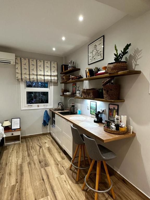 a kitchen with a counter and a table and chairs at Theodore's cosy apartment in Corfu