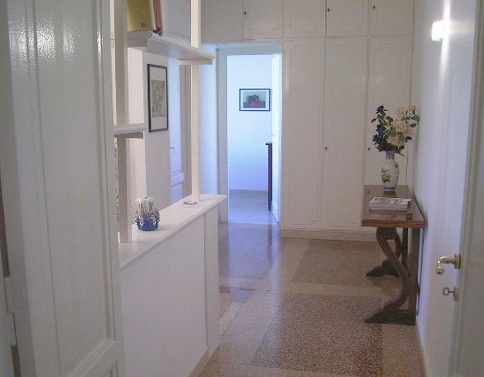 a room with a hallway with a table and a door at Cathy Apartment in Rome