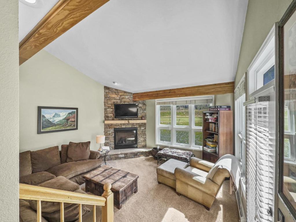 sala de estar con sofá y chimenea en Woods25 Townhome Condo en Copper Mountain