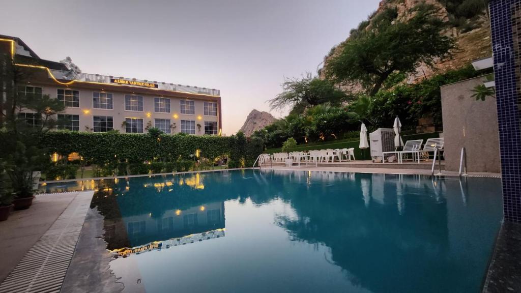 a large swimming pool in front of a building at Alwar Vanyaevilas in Alwar