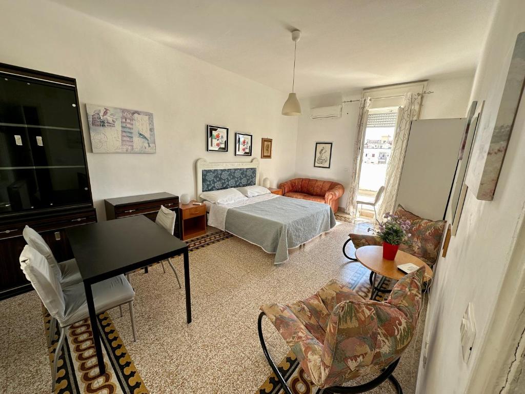 a bedroom with a bed and a living room at Appartamento Via Trevisani in Bari