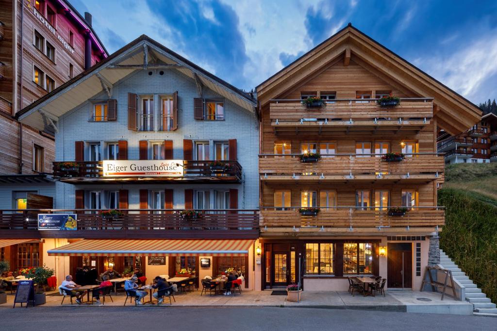 a building with people sitting outside of it at Eiger Guesthouse in Mürren