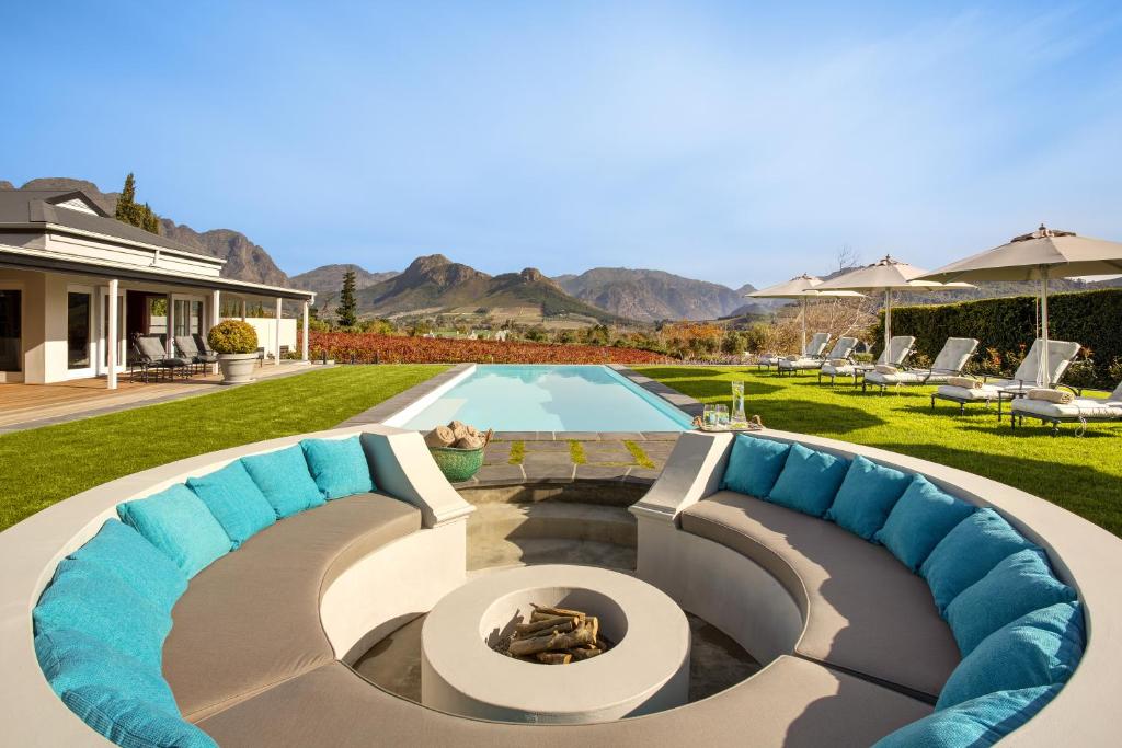 a backyard with a swimming pool and a house at La Providence in Franschhoek