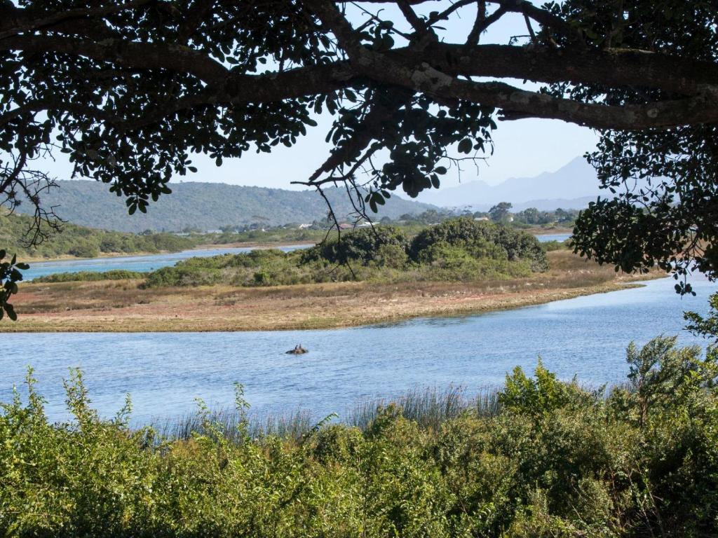 a river with a boat in the water at Water's Edge in Sedgefield