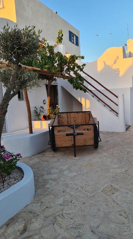 a bench in a courtyard with a tree and stairs at La Maison des Vagues in Sidi Kaouki