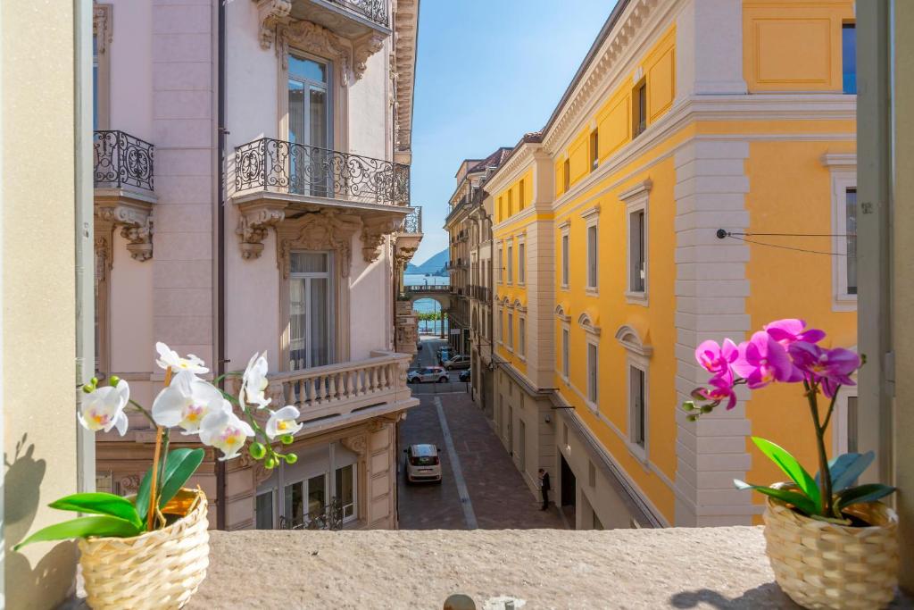 a view of a street with flowers on a balcony at Heart of Lugano - Happy Rentals in Lugano