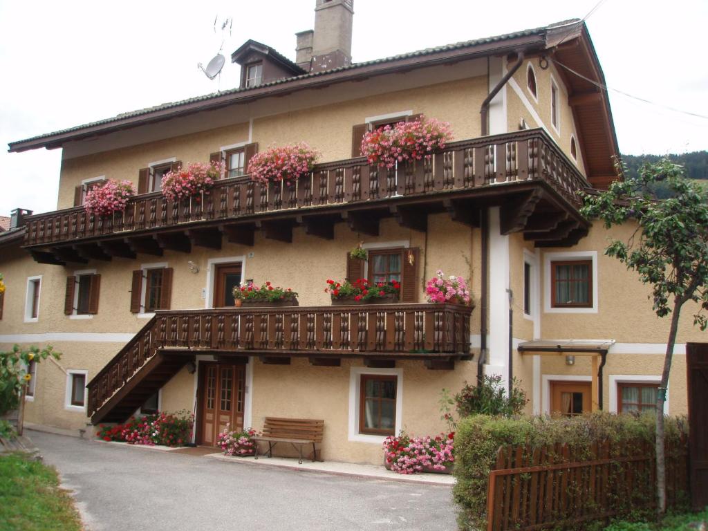 a building with flower boxes and balconies on it at Haus Schmiedhofer in Villabassa