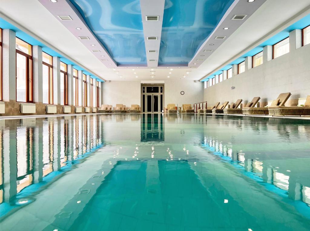 an indoor swimming pool with water in a building at Hotel Russia in Tsaghkadzor