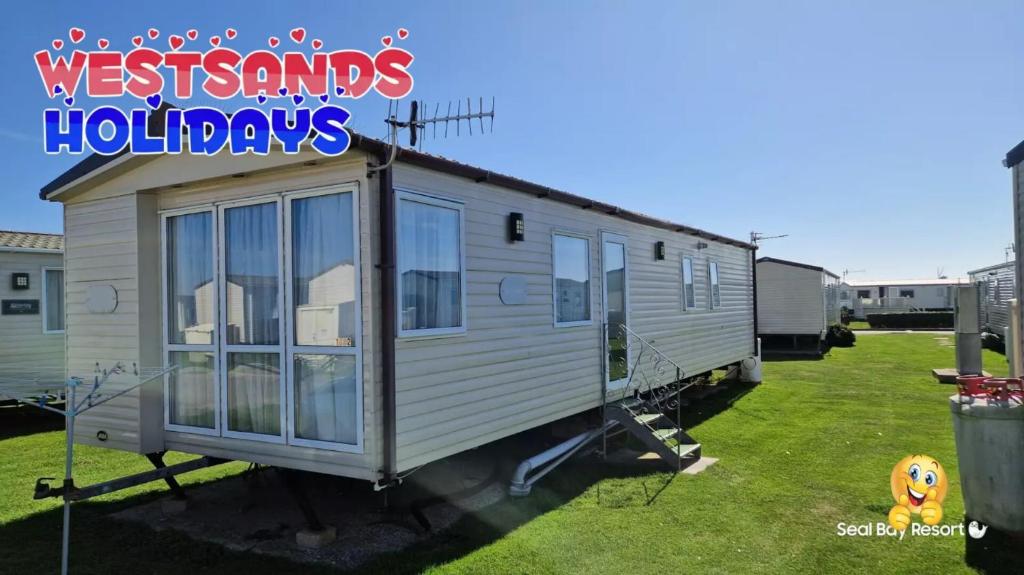a tiny house on display in a yard at 3 Bedroom Caravan at Seal Bay Resort in Selsey