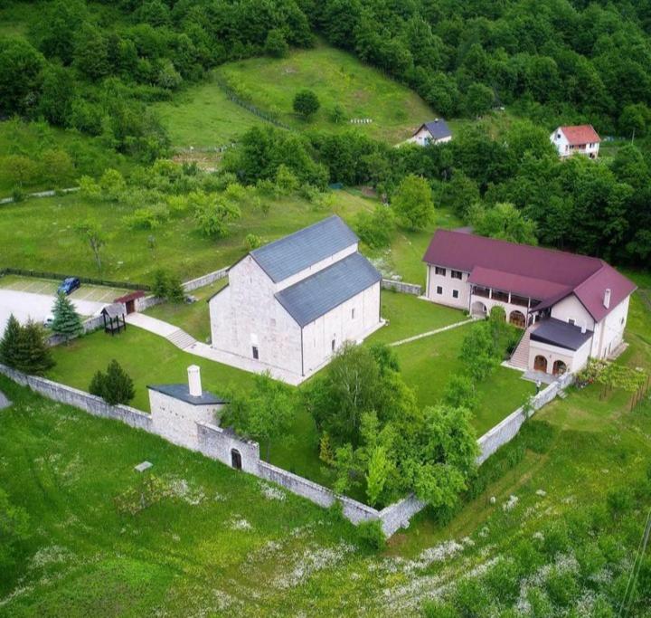 an aerial view of a large white barn with a house at Peaceful apartment in Pluzine