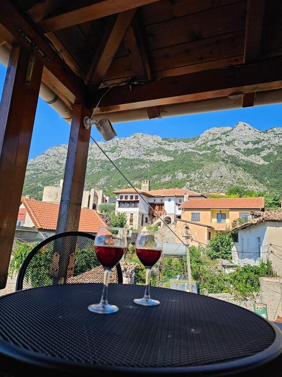 two glasses of red wine sitting on a table at Castle - inside,Voga Guesthause in Krujë
