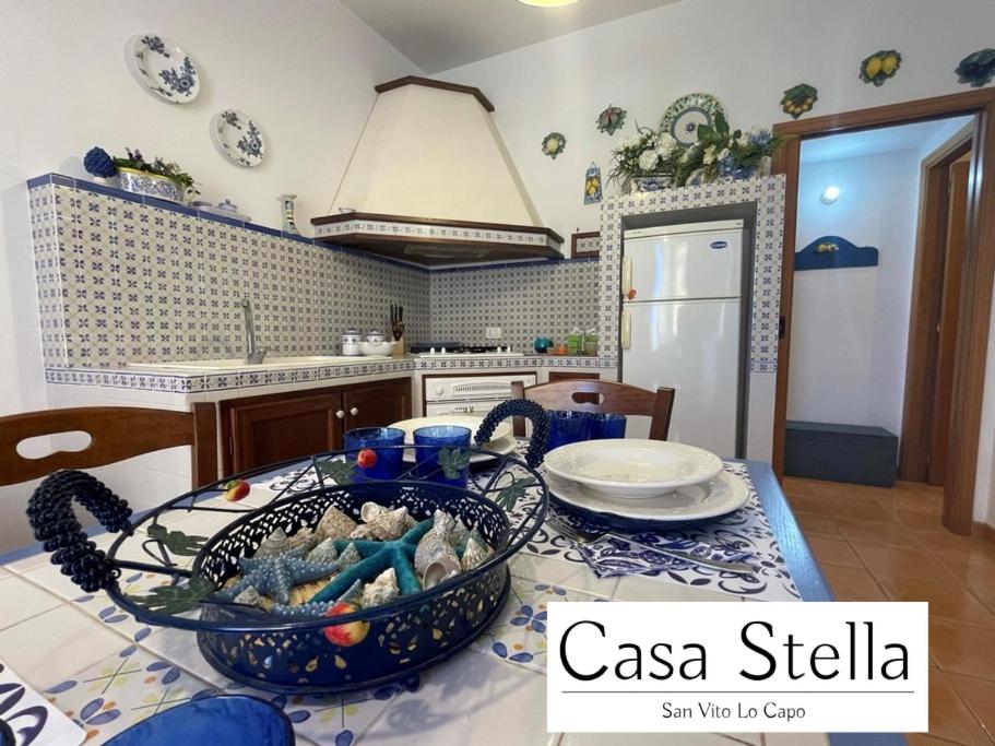 a kitchen with a table with a bowl of food on it at Casa Stella San Vito Lo Capo in San Vito lo Capo