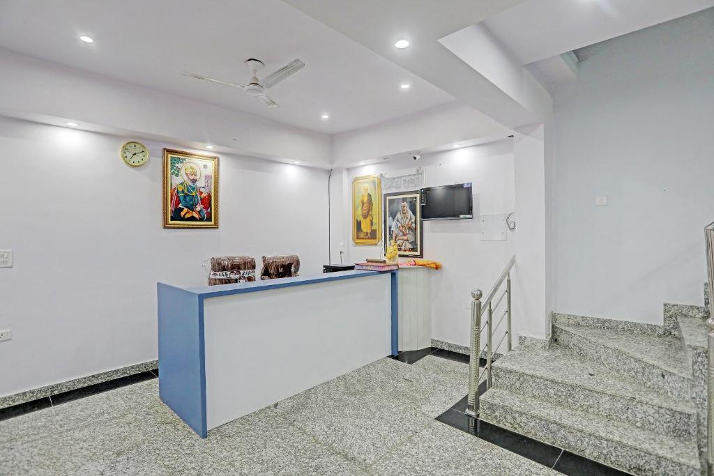 a lobby with stairs and a counter in a building at Hotel S B INN Paharganj in New Delhi