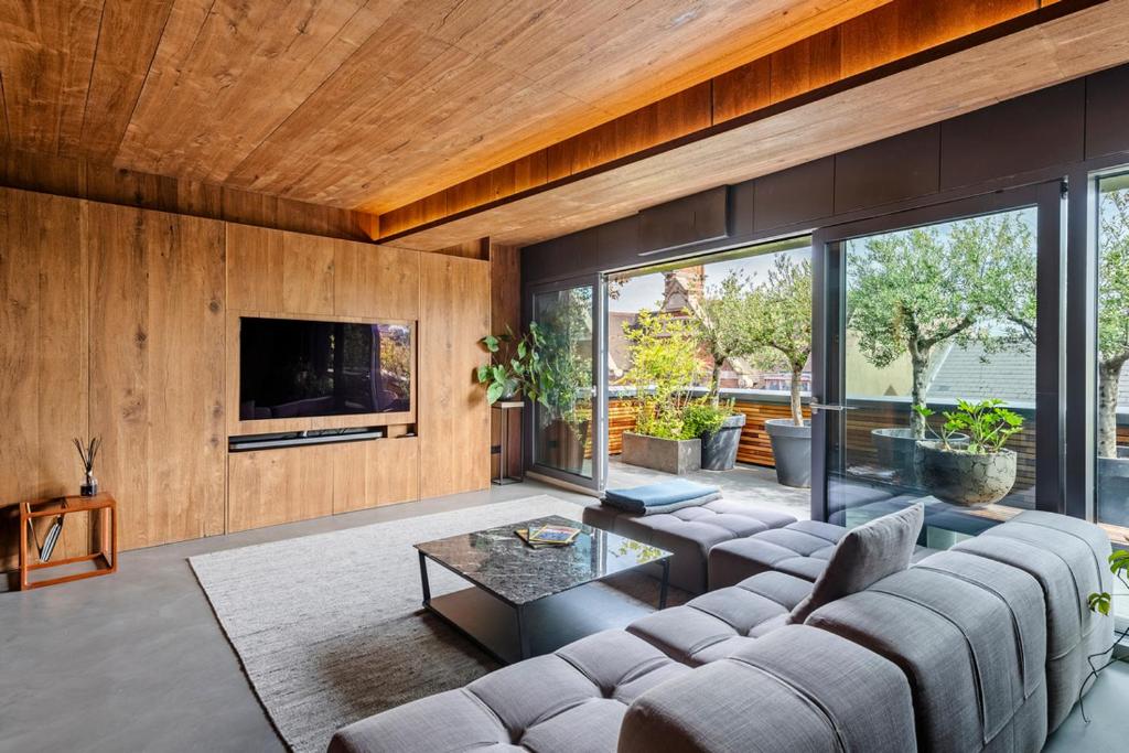 a living room with a couch and a tv at Sleepy Joes in London